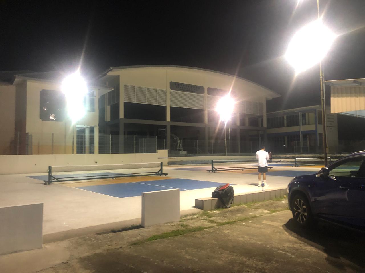 Tutong courts lit under floodlights at night
