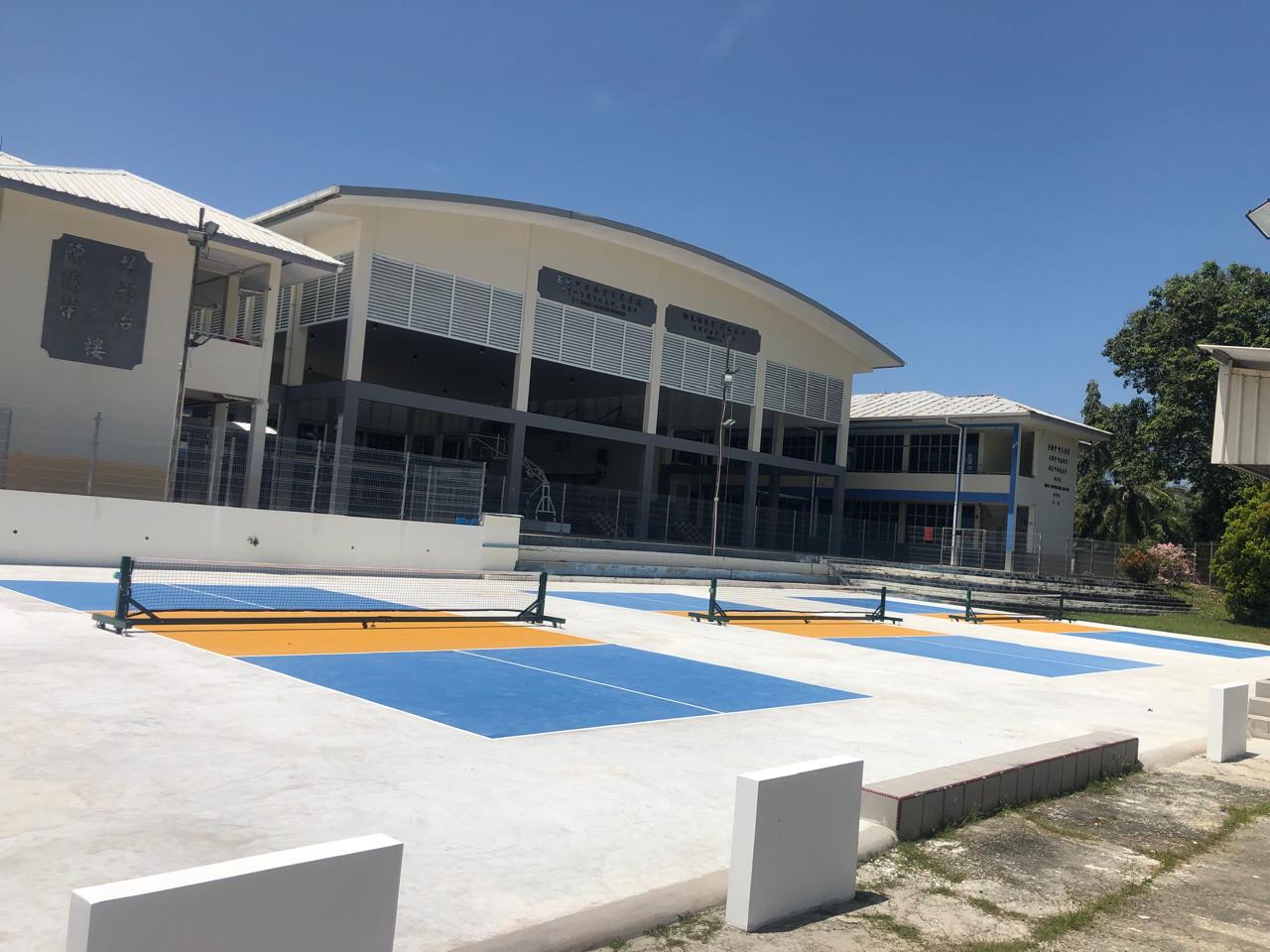 Three outdoor pickleball courts at Tutong, daytime wide view